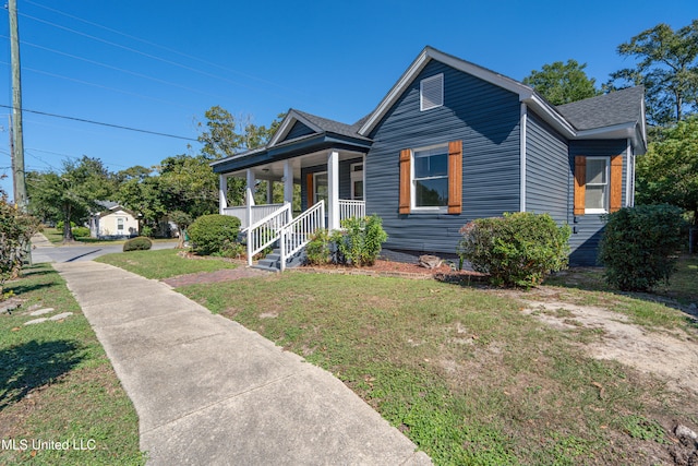 bungalow featuring a front lawn and covered porch