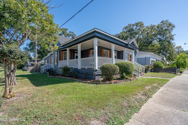 view of home's exterior featuring a porch and a lawn