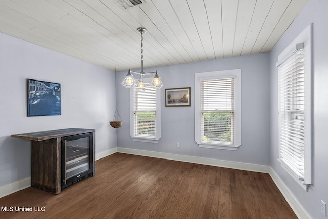 107 Lakepointe Dr, Madison, MS 39110 - unfurnished dining area featuring beverage cooler, dark wood finished floors, baseboards, and wooden ceiling