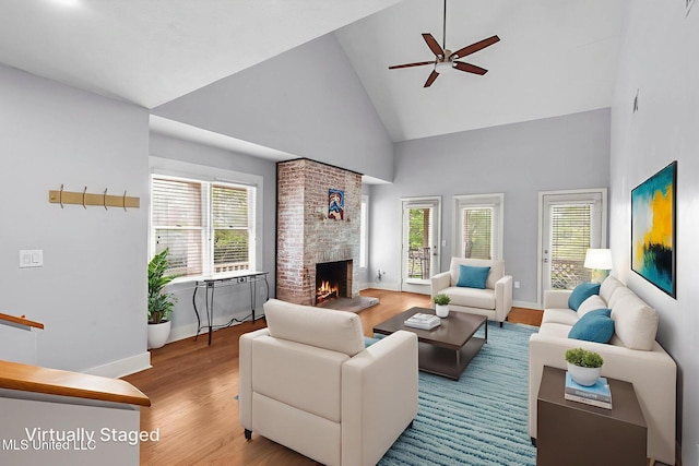 107 Lakepointe Dr, Madison, MS 39110 - living area with high vaulted ceiling, ceiling fan, a fireplace, wood finished floors, and baseboards