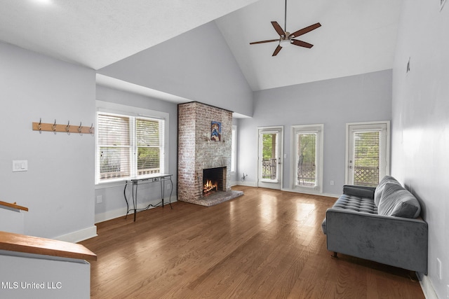 107 Lakepointe Dr, Madison, MS 39110 - living room with high vaulted ceiling, a ceiling fan, a fireplace, wood finished floors, and baseboards