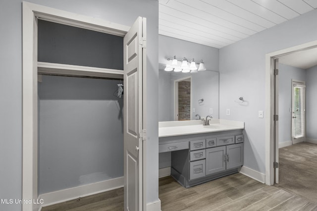 107 Lakepointe Dr, Madison, MS 39110 - bathroom with vanity, wood finished floors, a walk in closet, and baseboards