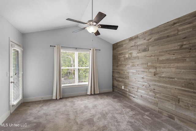 107 Lakepointe Dr, Madison, MS 39110 - empty room with ceiling fan, carpet, baseboards, wood walls, and vaulted ceiling