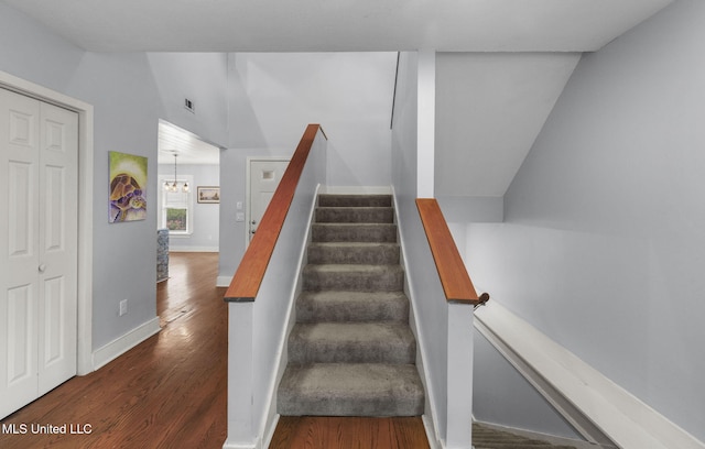 107 Lakepointe Dr, Madison, MS 39110 - staircase with wood finished floors, vaulted ceiling, a chandelier, and baseboards