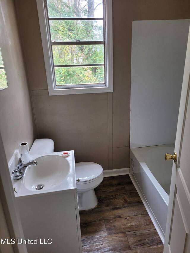 202 Fisher St, Batesville, MS 38606 - bathroom featuring toilet, a bathtub, hardwood / wood-style floors, and vanity