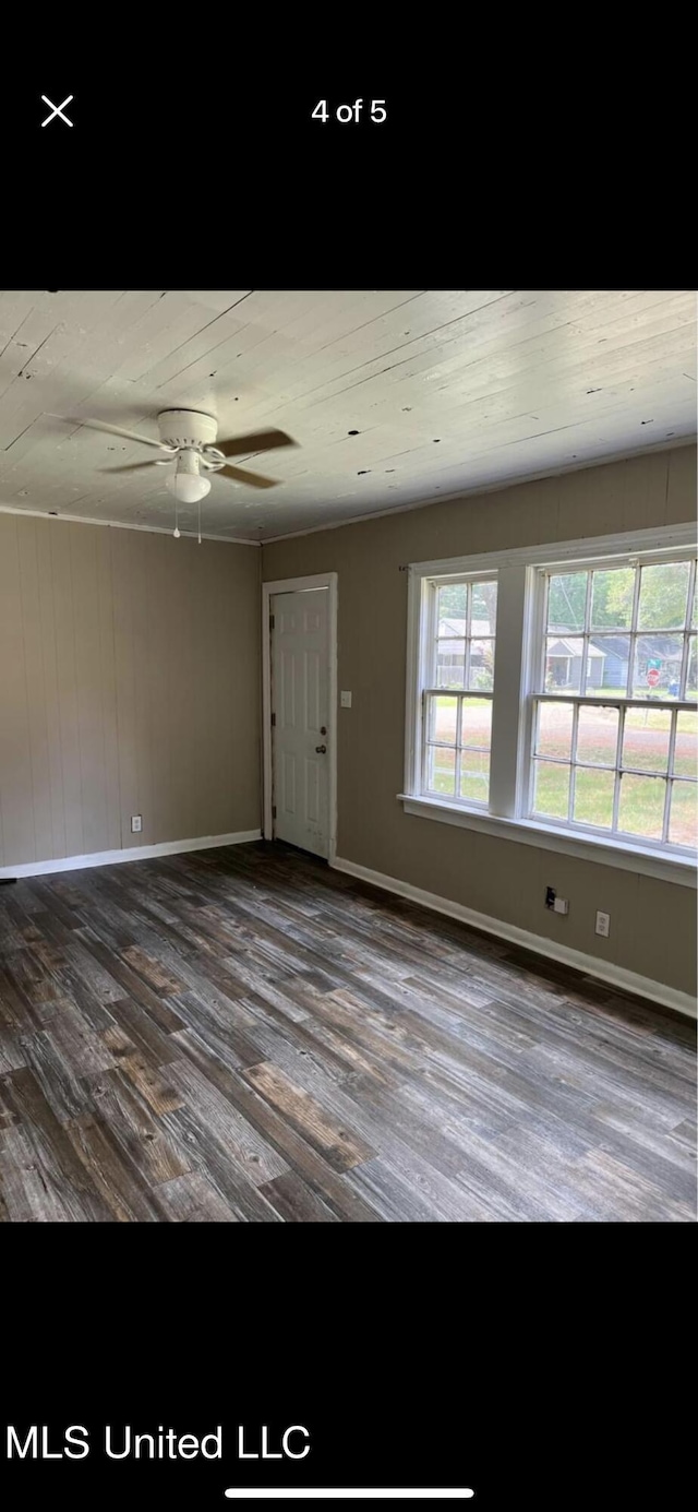 202 Fisher St, Batesville, MS 38606 - empty room with ceiling fan and dark wood-type flooring