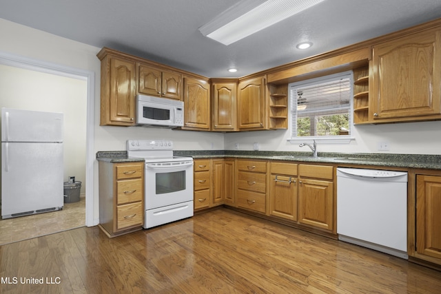 148 Acacia Ave, Biloxi, MS 39530 - kitchen with white appliances, open shelves, dark countertops, dark wood-type flooring, and brown cabinets