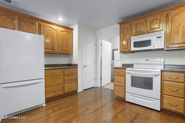 148 Acacia Ave, Biloxi, MS 39530 - kitchen featuring white appliances, dark wood-style flooring, recessed lighting, brown cabinets, and dark stone countertops