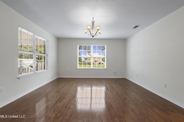 148 Acacia Ave, Biloxi, MS 39530 - unfurnished room featuring a chandelier, plenty of natural light, and wood finished floors