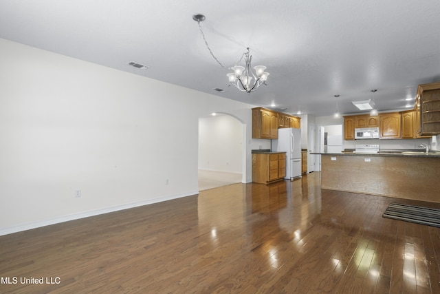 148 Acacia Ave, Biloxi, MS 39530 - unfurnished living room featuring arched walkways, a chandelier, and dark wood-style floors