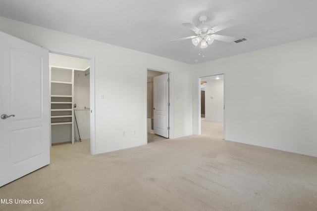 148 Acacia Ave, Biloxi, MS 39530 - unfurnished bedroom featuring a spacious closet, light carpet, a closet, and ceiling fan