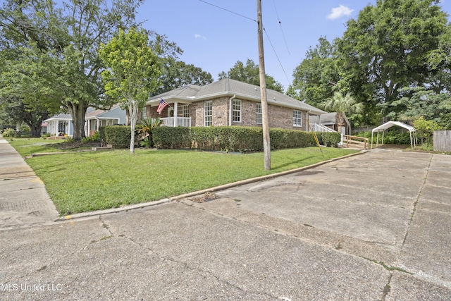 148 Acacia Ave, Biloxi, MS 39530 - view of front facade featuring a carport, a front lawn, brick siding, and concrete driveway