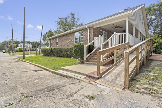 148 Acacia Ave, Biloxi, MS 39530 - view of front of home featuring a ceiling fan, a front yard, brick siding, and covered porch