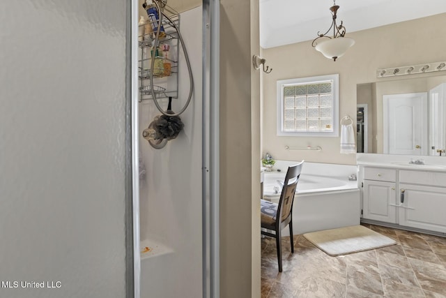 bathroom featuring a garden tub, vanity, and a shower