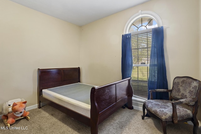 carpeted bedroom featuring baseboards