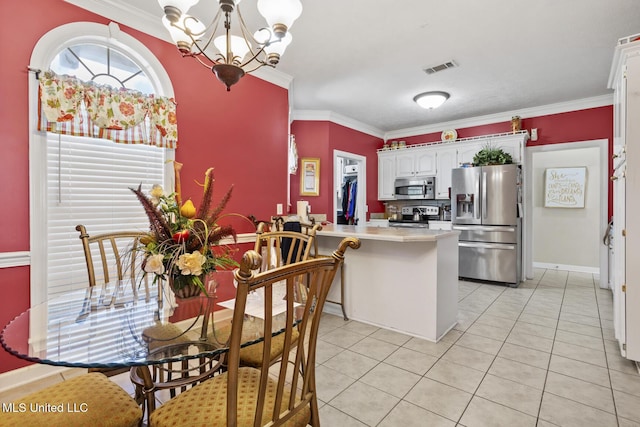 kitchen with stainless steel appliances, a peninsula, a chandelier, ornamental molding, and light countertops