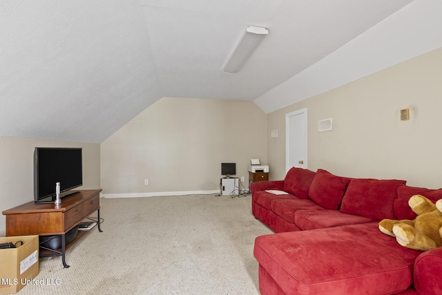 living room featuring lofted ceiling, carpet flooring, and baseboards