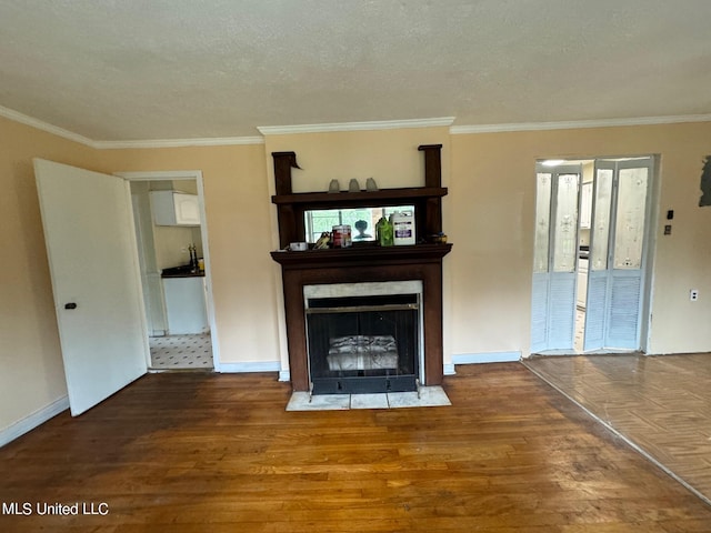 unfurnished living room featuring crown molding, wood-type flooring, and a textured ceiling