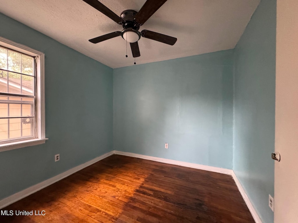 empty room with hardwood / wood-style floors, a textured ceiling, and ceiling fan