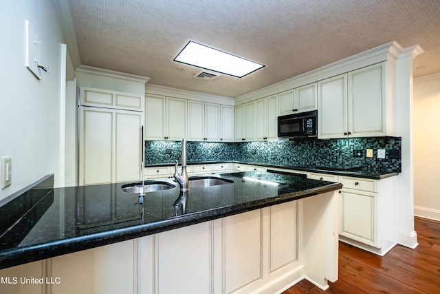 kitchen with wood-type flooring, sink, ornamental molding, dark stone countertops, and decorative backsplash