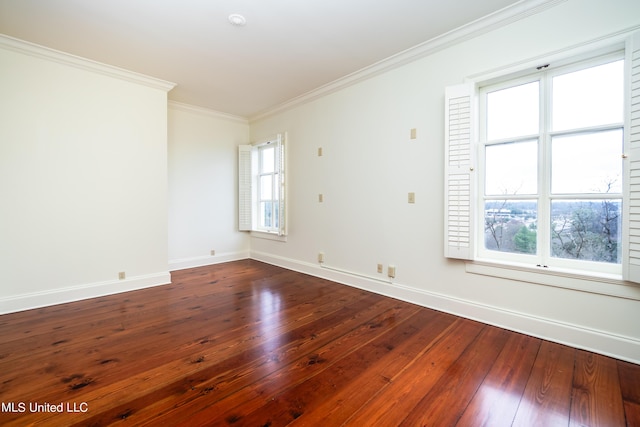 unfurnished room with a wealth of natural light, dark wood finished floors, baseboards, and ornamental molding