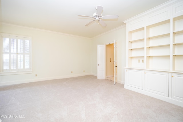 carpeted empty room featuring crown molding and ceiling fan