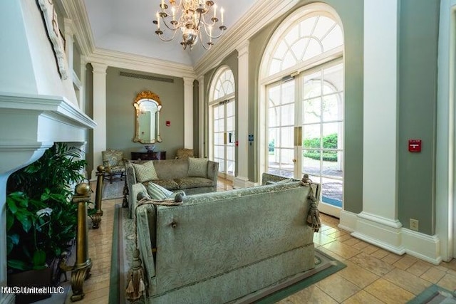 interior space with an inviting chandelier, crown molding, light tile patterned flooring, and a wealth of natural light