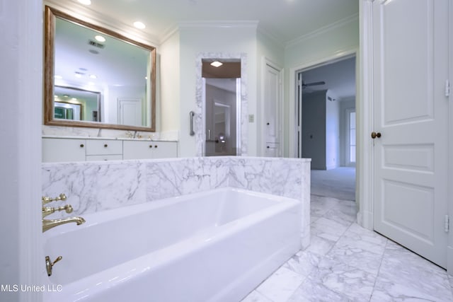 bathroom with vanity, crown molding, and a washtub