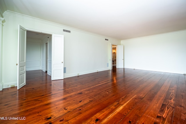 spare room with crown molding and dark hardwood / wood-style flooring