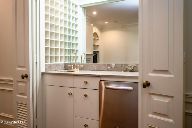 interior space featuring white cabinetry, crown molding, and sink