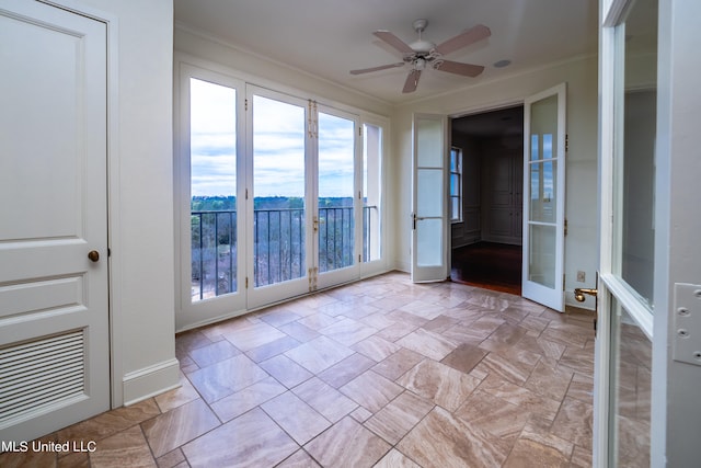 unfurnished sunroom featuring french doors and ceiling fan