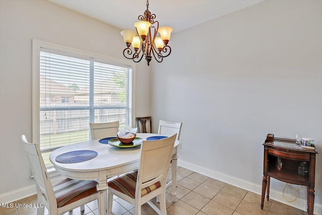 dining room with an inviting chandelier, baseboards, and light tile patterned flooring