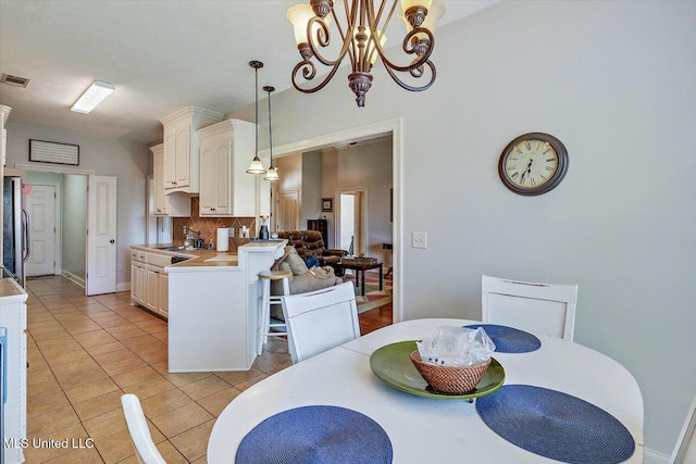 dining room with visible vents, a chandelier, and light tile patterned flooring