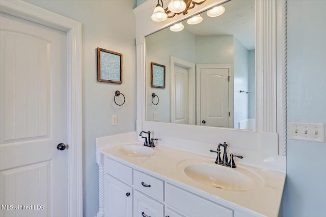 bathroom with a sink and double vanity