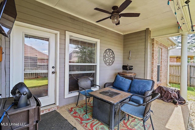 sunroom / solarium featuring a ceiling fan, outdoor lounge area, and a wealth of natural light