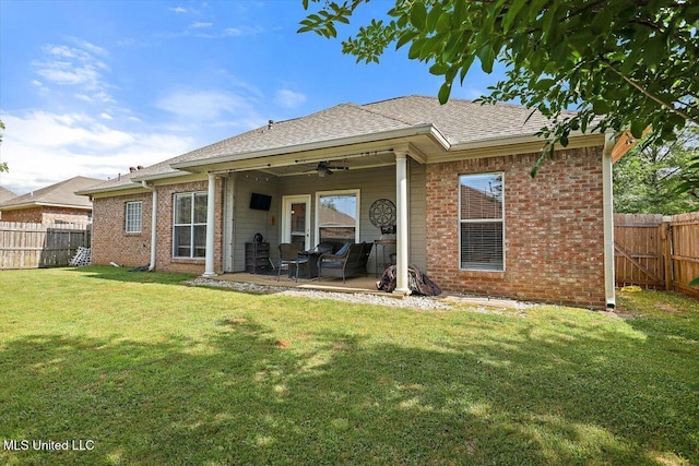 rear view of property with brick siding, ceiling fan, and a fenced backyard