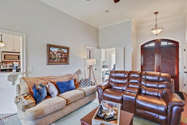 living area featuring arched walkways, ornamental molding, and french doors