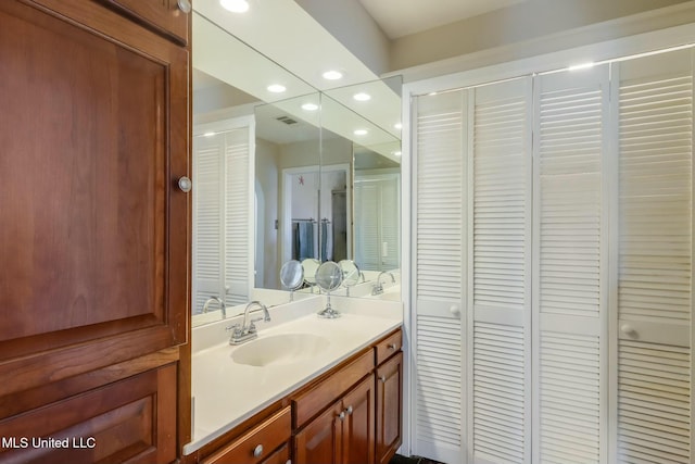 bathroom featuring recessed lighting, a closet, visible vents, and vanity