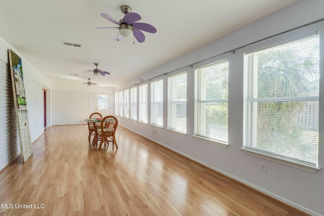 unfurnished sunroom featuring visible vents