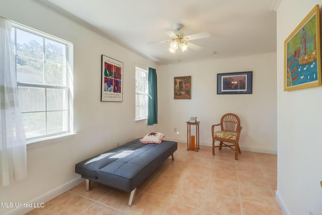 sitting room with light tile patterned floors, baseboards, and crown molding