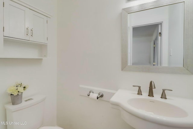 bathroom featuring toilet and a sink