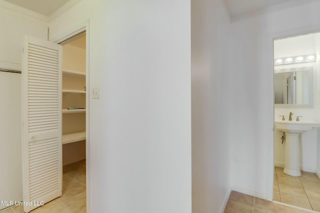 interior space with a sink, tile patterned flooring, and a closet