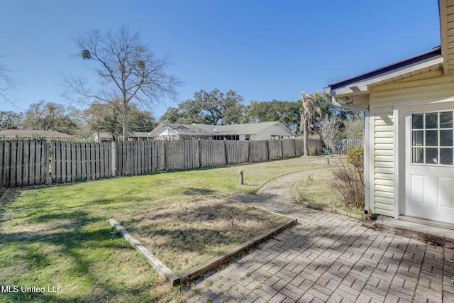 view of yard with a fenced backyard and a patio