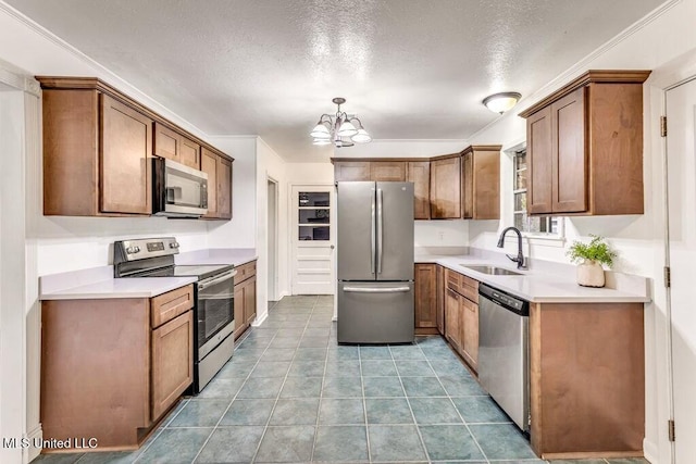 kitchen with sink, light tile patterned floors, appliances with stainless steel finishes, an inviting chandelier, and decorative light fixtures