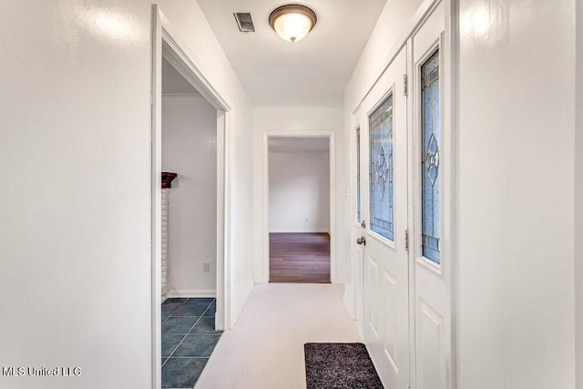 hallway featuring tile patterned flooring