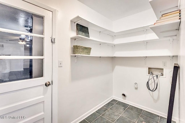 laundry room featuring dark tile patterned floors, washer hookup, and ceiling fan