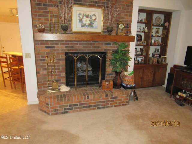 living room with a brick fireplace and carpet floors