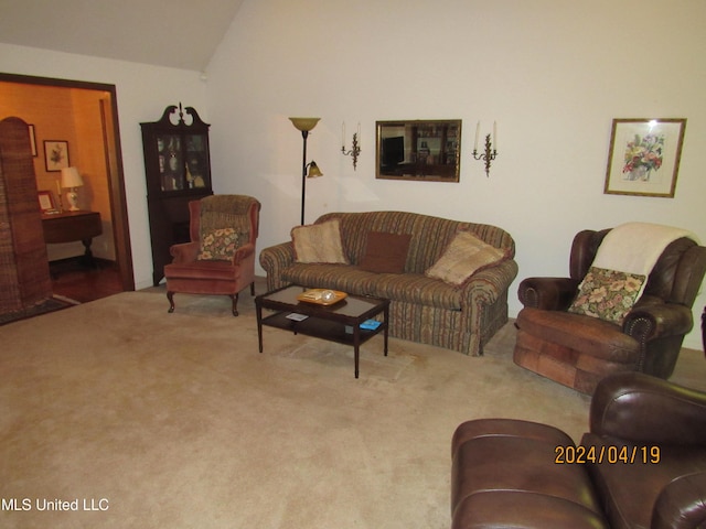 living room with lofted ceiling and carpet flooring