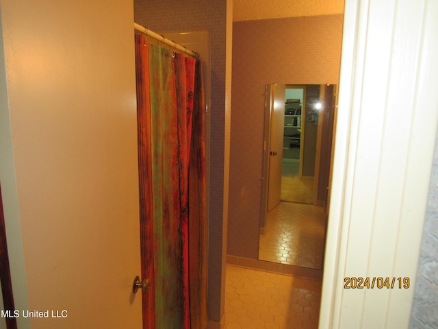 hallway featuring tile patterned flooring