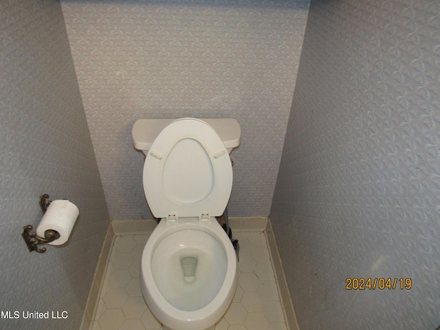 bathroom with tile patterned flooring and toilet